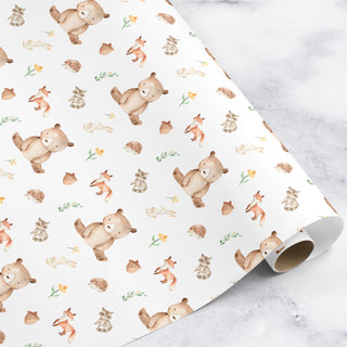 Roll of wrapping paper with bear and fox pattern on a marble surface