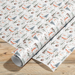 Roll of patterned paper with fox animal design on a wooden surface